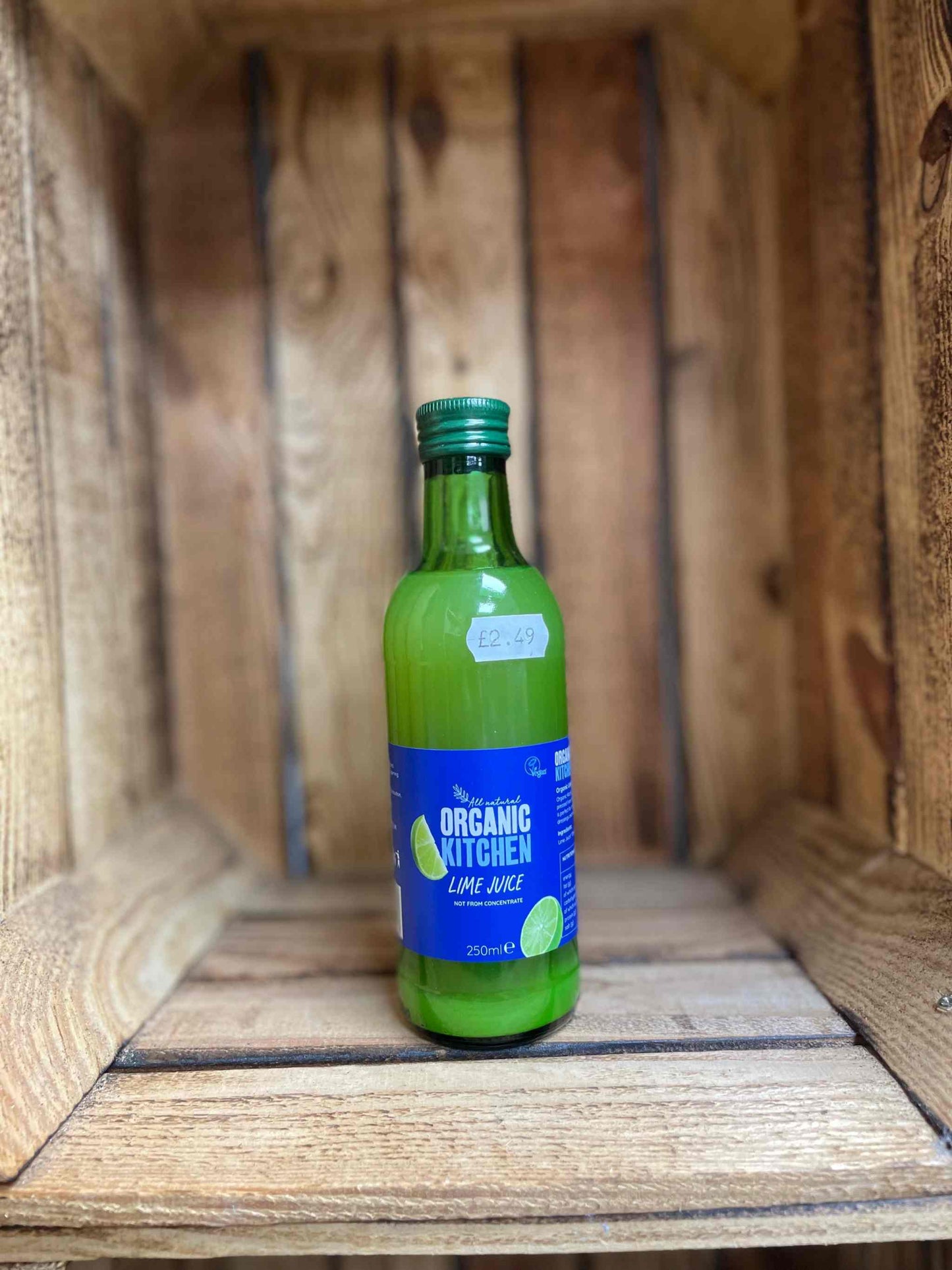 Organic Kitchen bottles of lime juice in wooden crate.