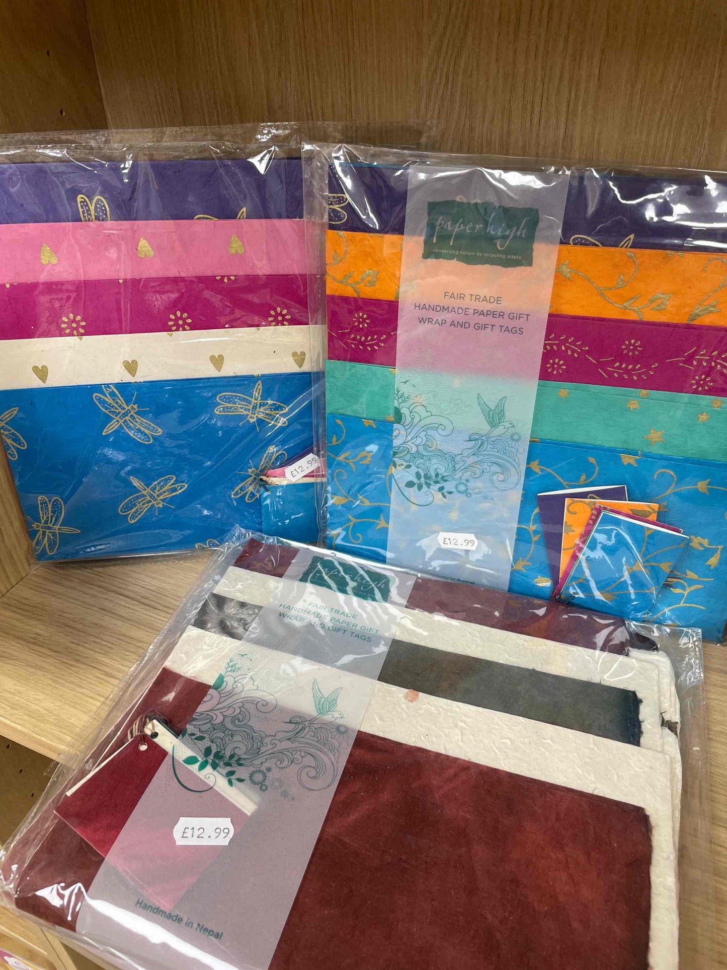 Lokta 5 Pack handmade fairtrade paper, eco-friendly and colorful sheets displayed on a shelf.