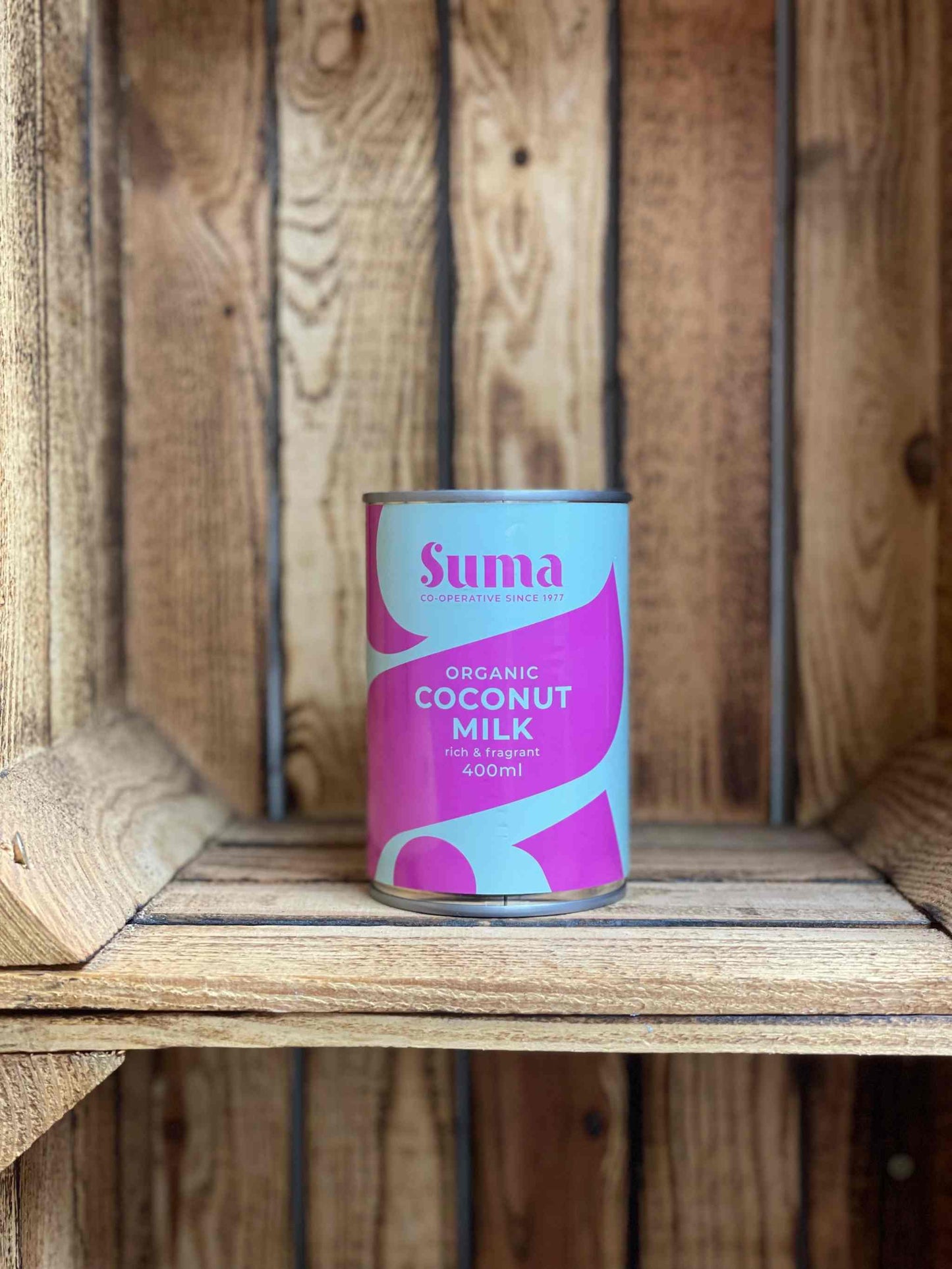 SUMA Tins & Jars Organic Coconut Milk on rustic wooden background