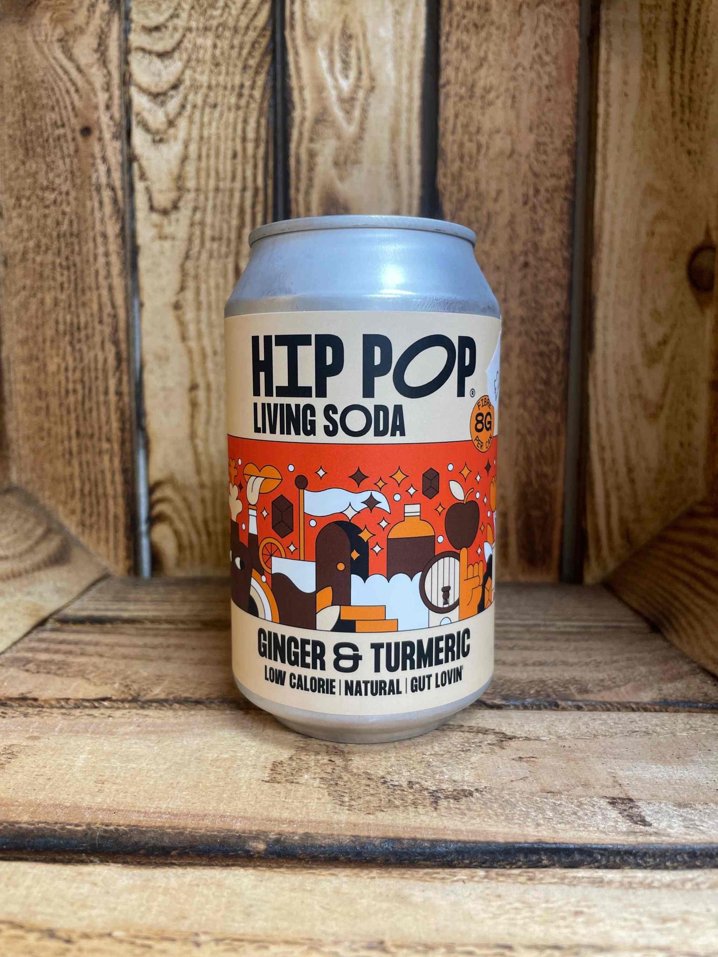 Ginger Turmeric Hip Pop can on wooden surface, low calorie natural soda.