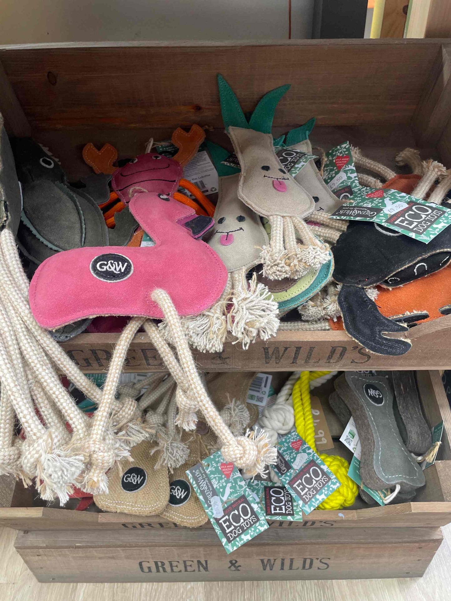 Green & Wild's eco-friendly dog toys in a wooden display box.