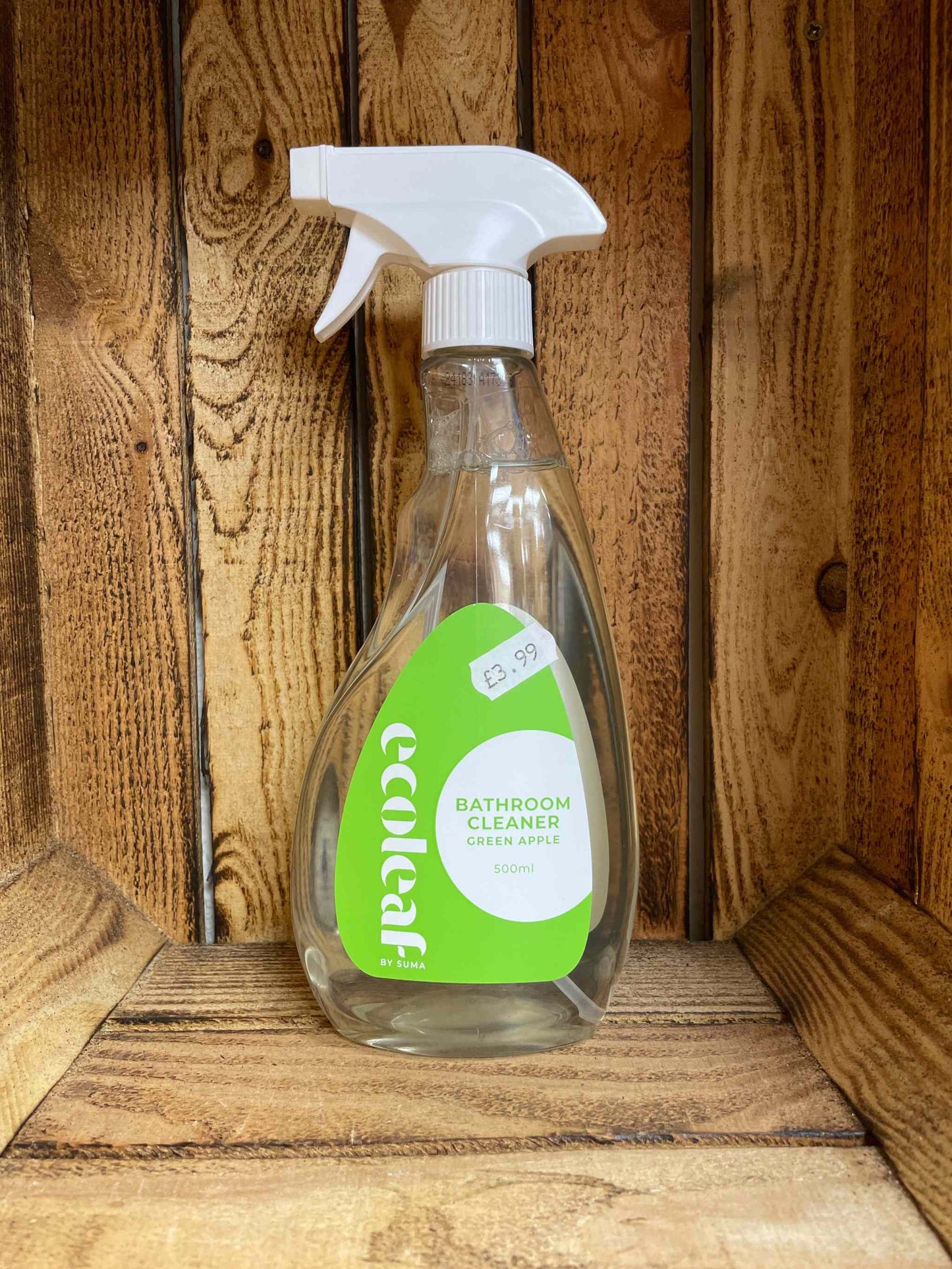 Ecoleaf bathroom cleaner in a spray bottle on a wooden background.