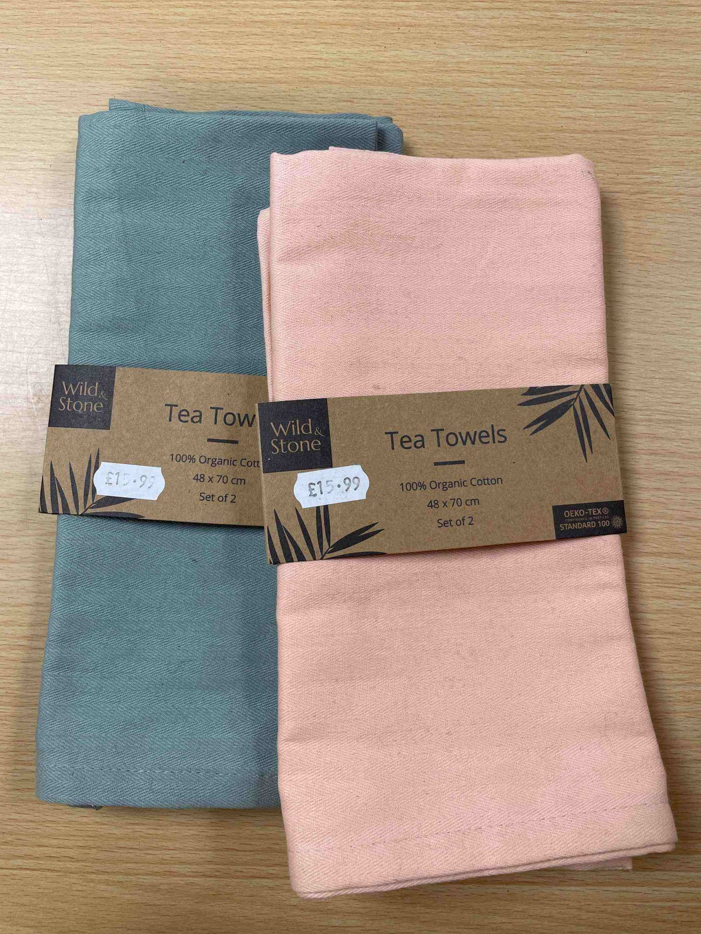Wild & Stone Tea Towels in dove grey and soft peach hues, crafted from premium organic cotton, adding elegance and sustainability to any kitchen.