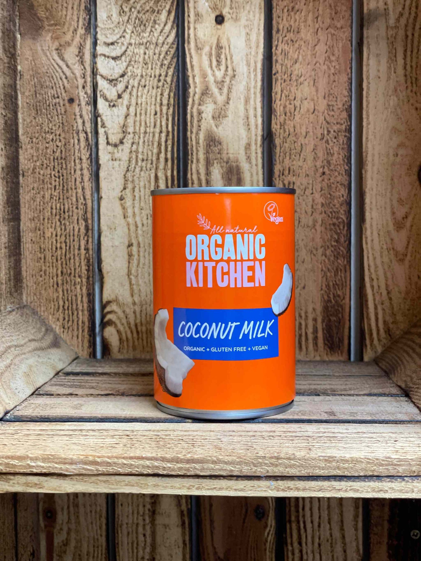 Organic kitchen coconut milk can on rustic wooden shelf