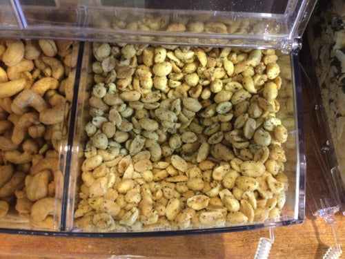 Garlic & Herb Peanuts in display tray showing golden roasted and herb-coated nuts.
