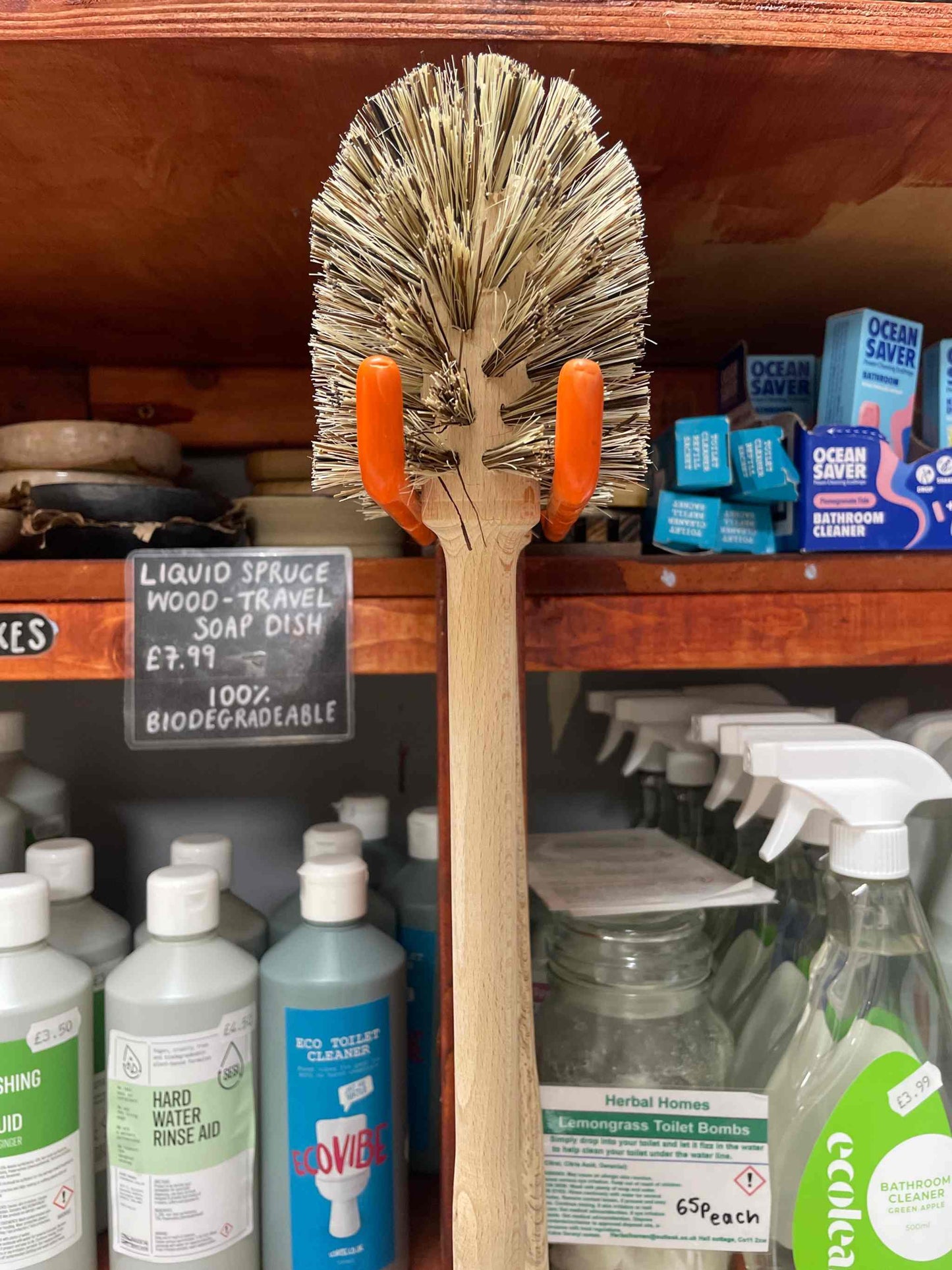 Large toilet brush with ergonomic handle and anti-bacterial bristles displayed on store shelf.