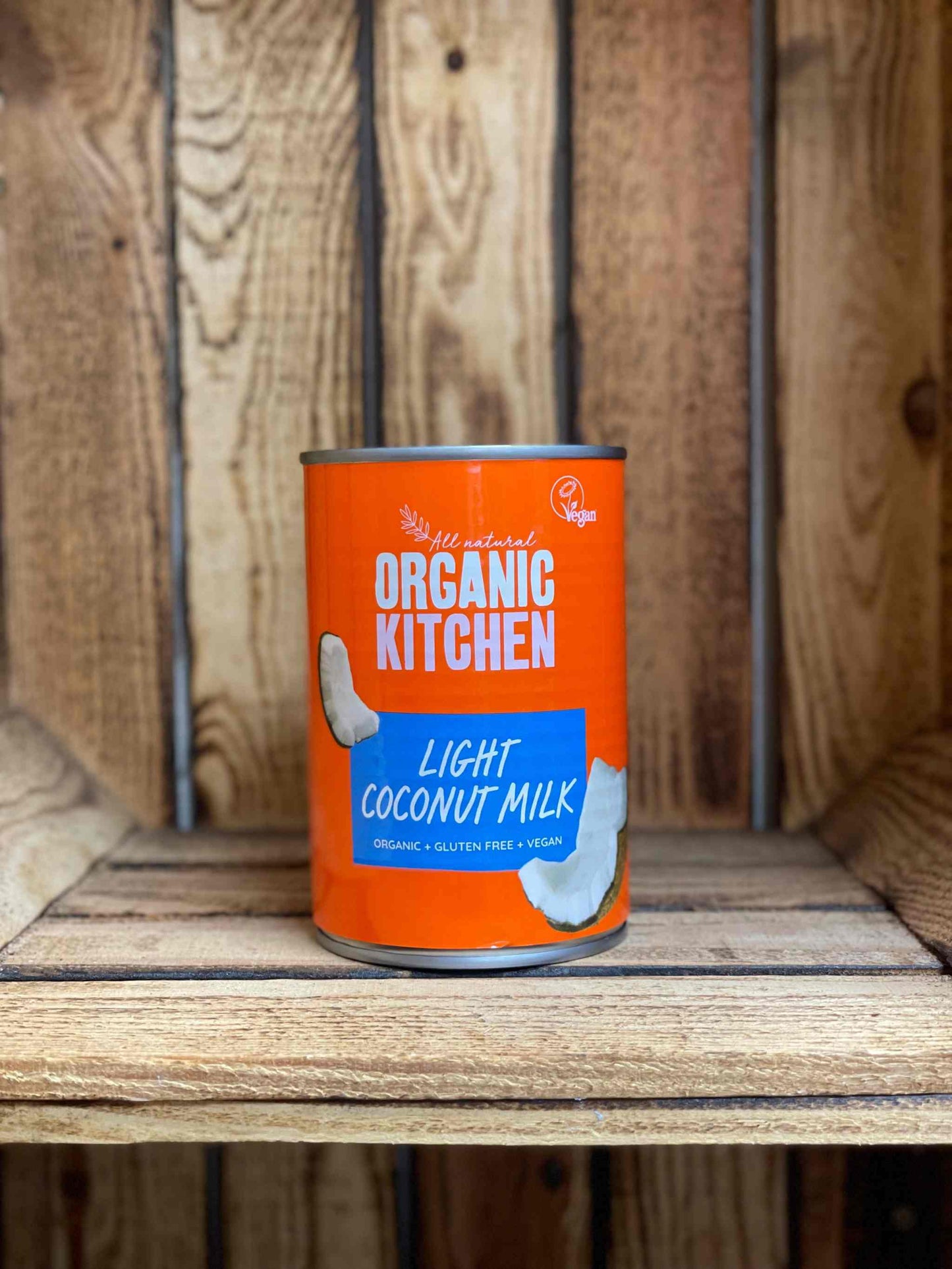Organic kitchen light coconut milk can on rustic wooden shelf