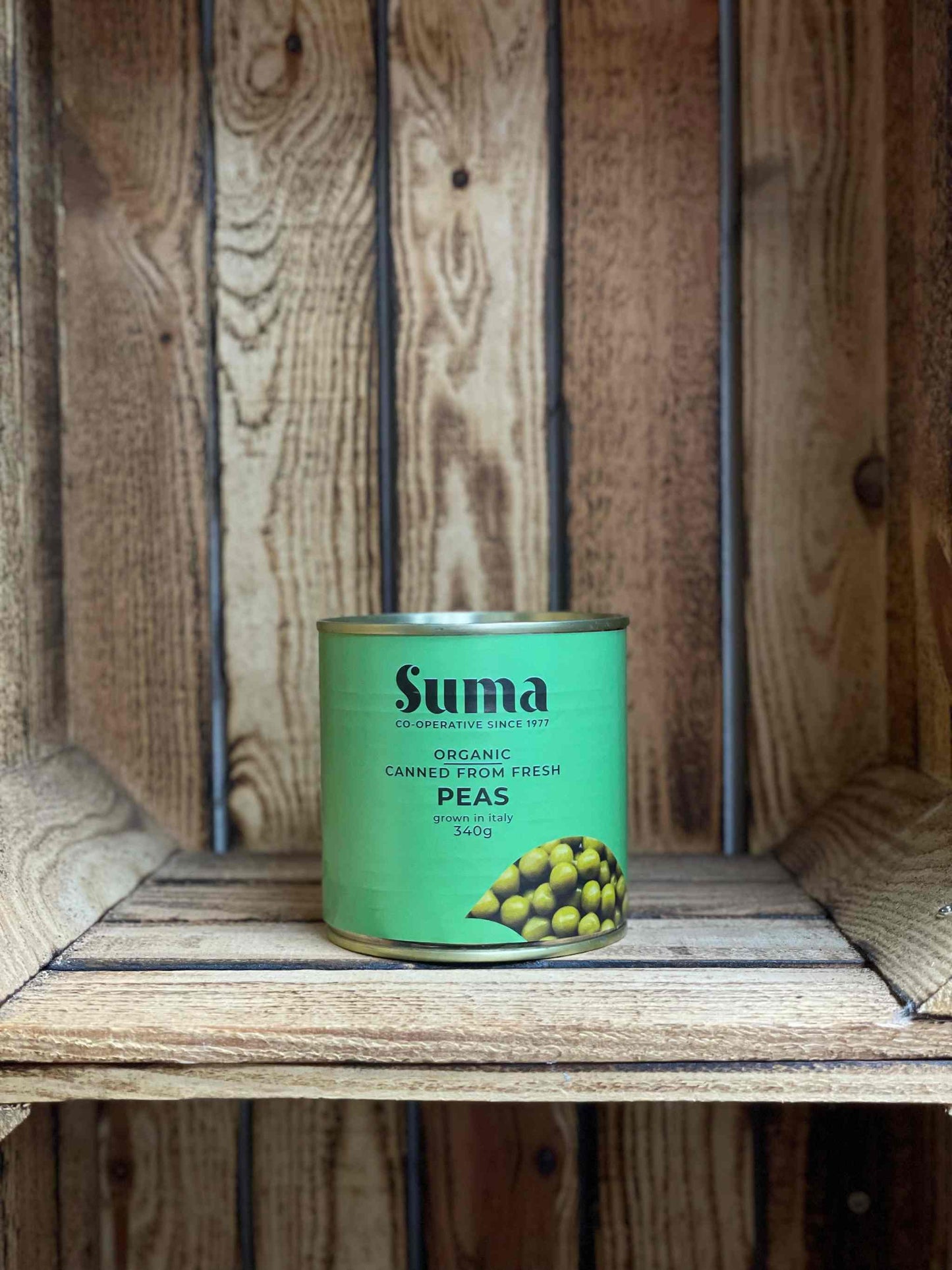 SUMA Tins & Jars coconut milk on wooden shelf, organic and versatile cooking ingredient.
