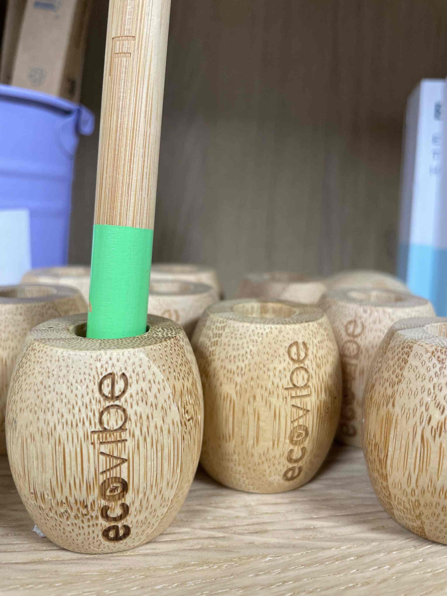 Bamboo Ecovibe Toothbrush Holder on a shelf.