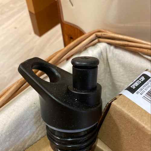 Sports cap displayed in packaging box, highlighting durable and versatile design.