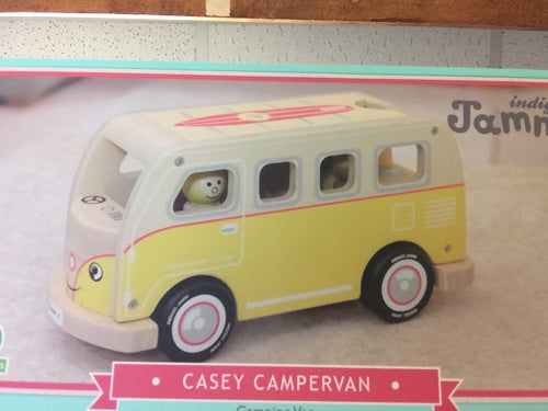 Toy model of Casey the Campervan in yellow and white with expressive eyes.