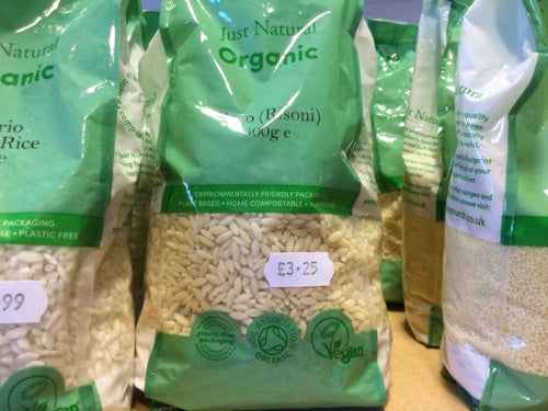 Organic orzo packages on display, showcasing sustainable, vegan, and environmentally friendly labeling.