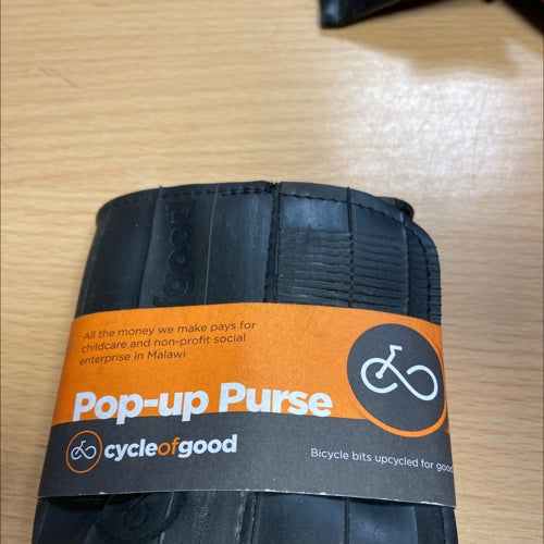 Eco-friendly pop-up coin purse made from recycled materials, featuring compact design and sustainable style.