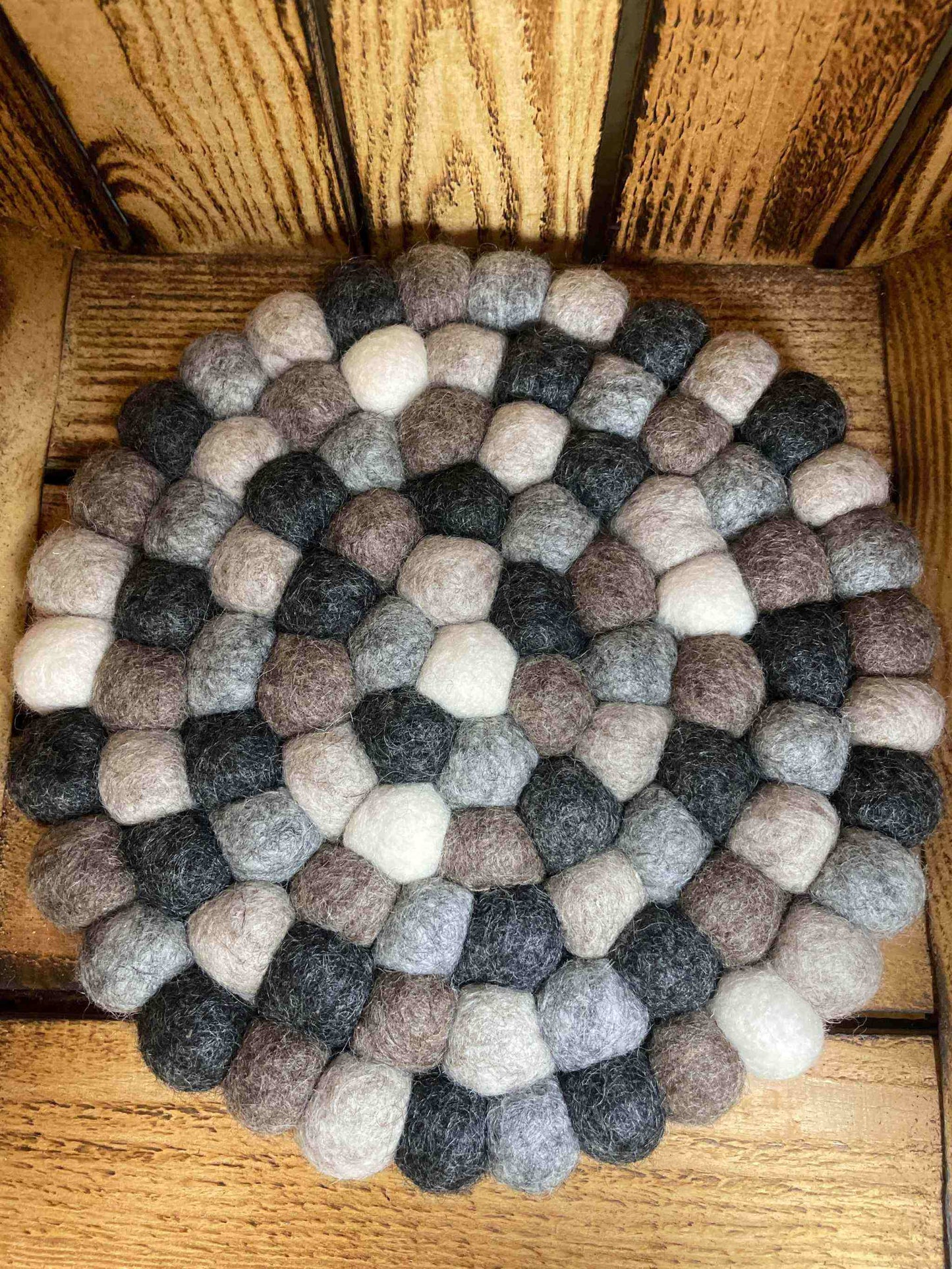 Handmade felt trivet with neutral colors and a minimalist design, crafted for eco-friendly home decor.