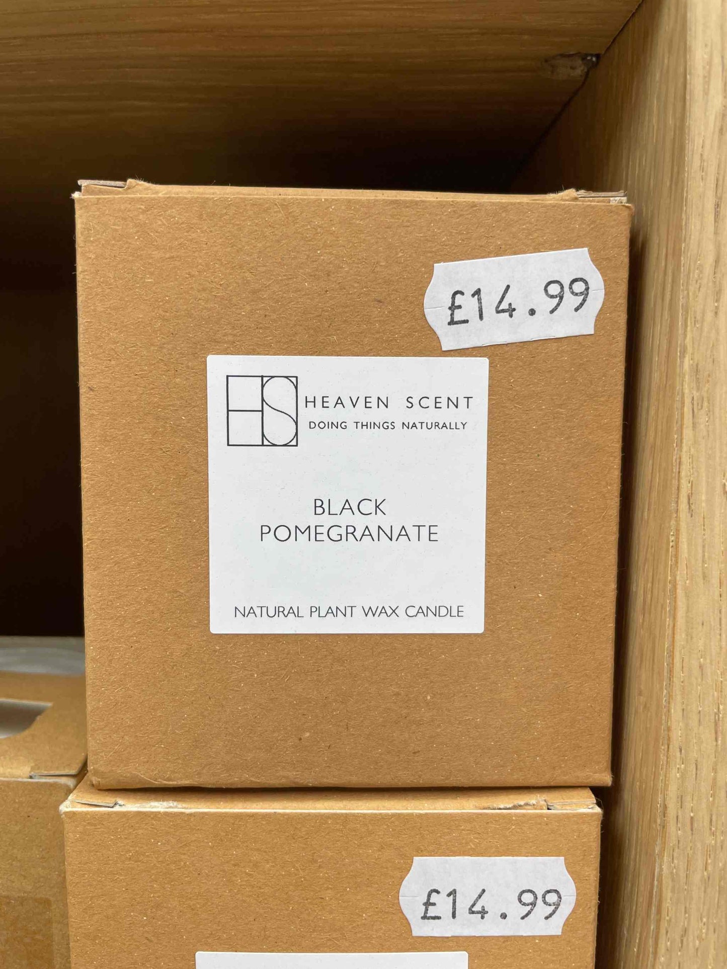 Black Pomegranate Candle in eco-friendly packaging with price tag.