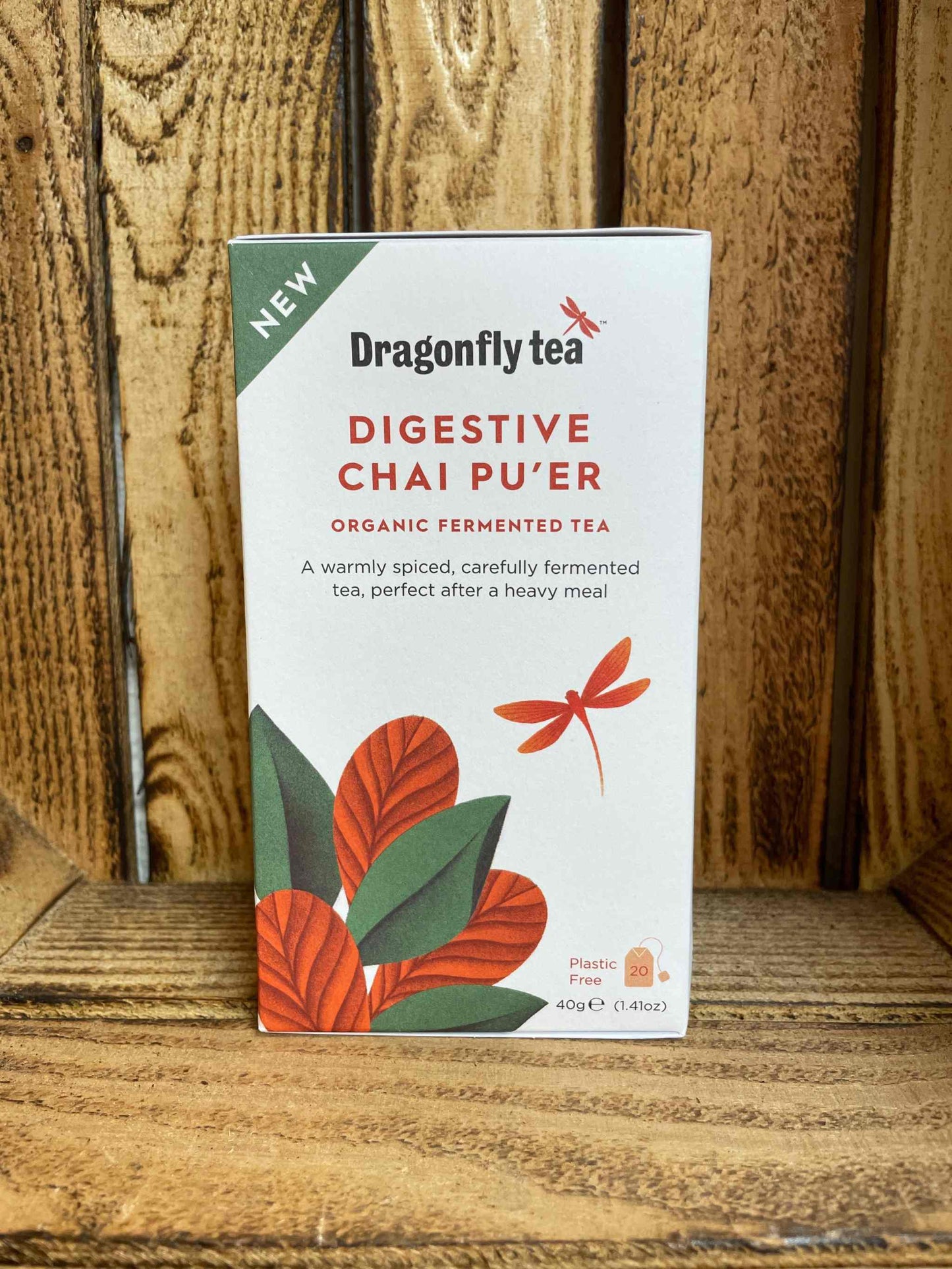 Digestive Chai Pu'er Dragonfly tea box on wooden background.