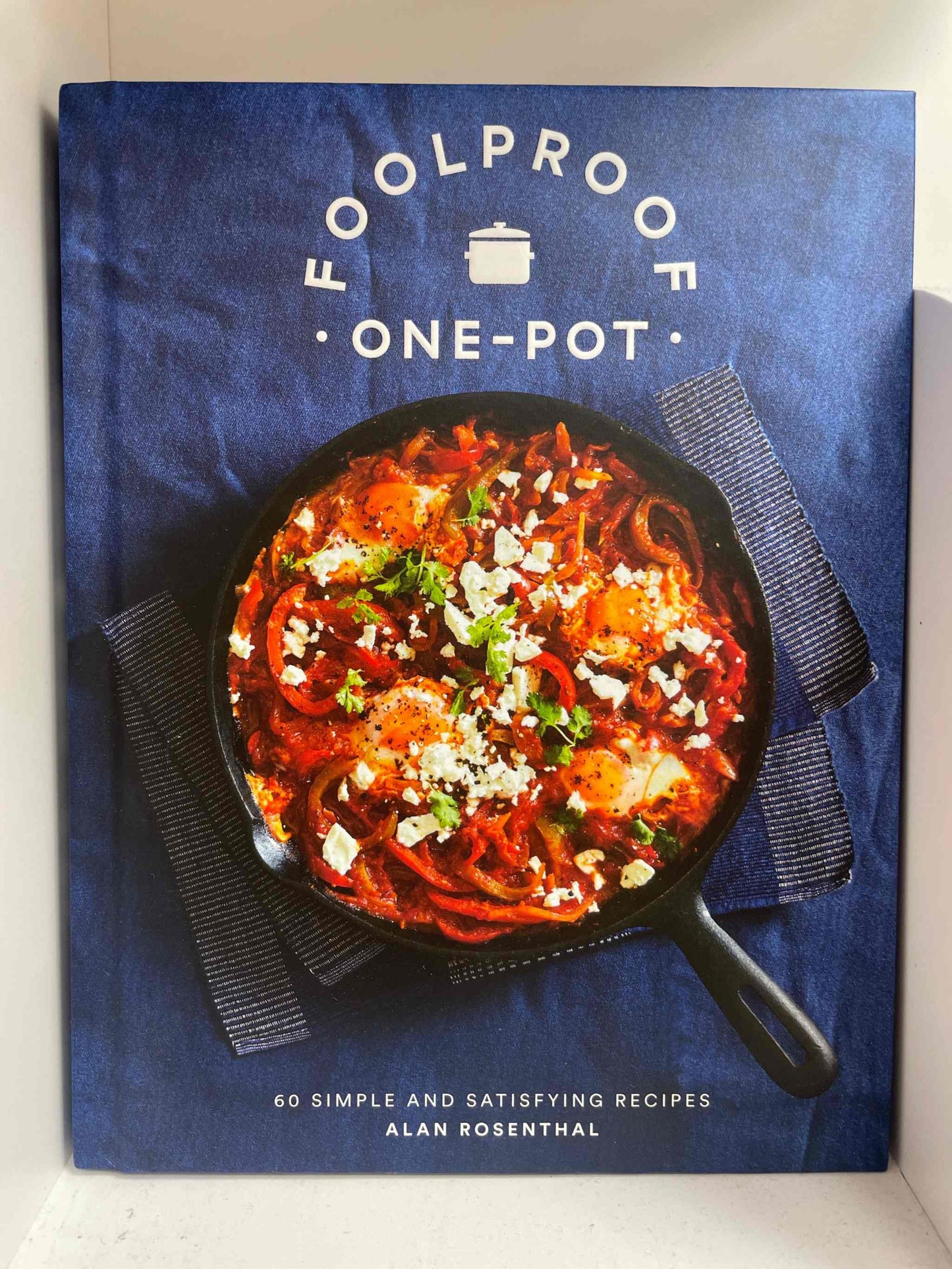 Foolproof One-Pot cookbook cover featuring a hearty meal in a skillet on a blue background.