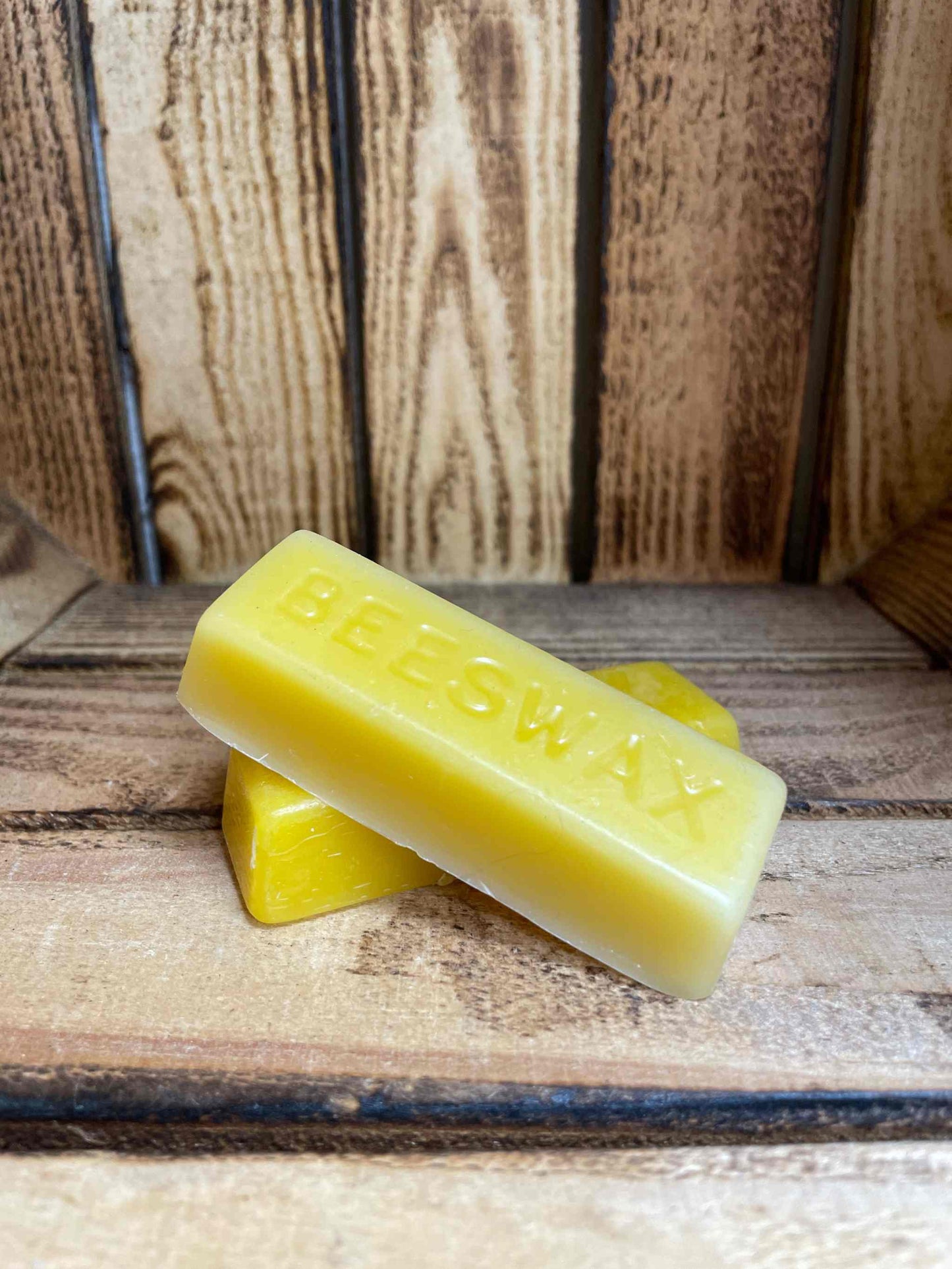 Bees Wax Bar medium on wooden surface for natural skincare and eco-friendly use.