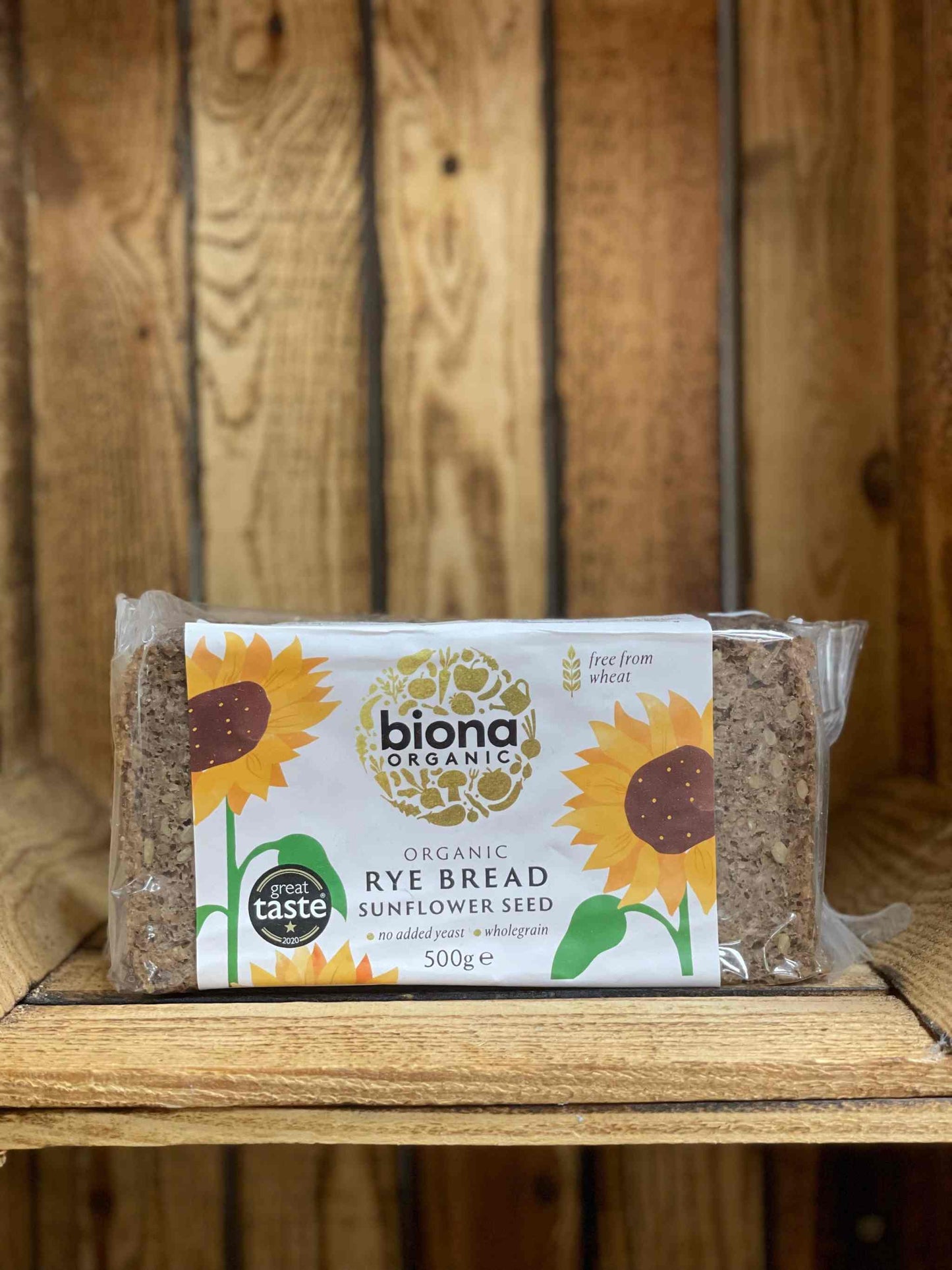 Organic Rye Bread with Sunflower Seeds on rustic wooden shelf, nutritious and artisanal.