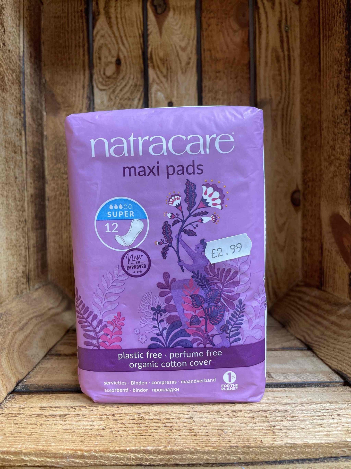 Natracare Maxi Pads packaging on wooden shelf.