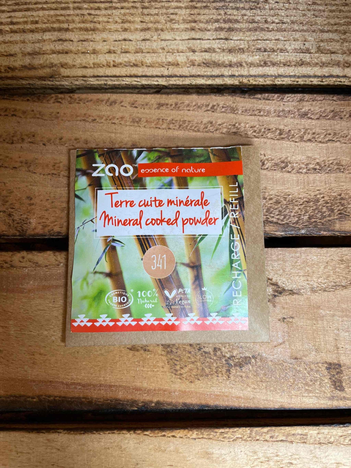 Cooked powder refill package on a wooden surface.