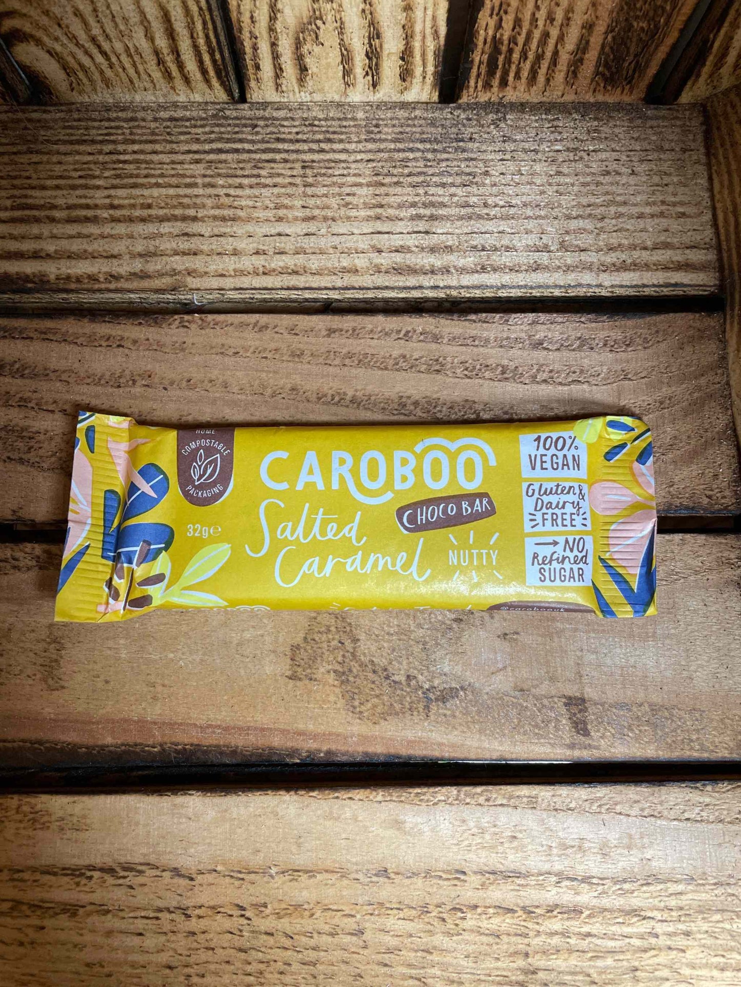 Carob Bar-Salt, Caramel & Nutty on wooden surface, vegan.