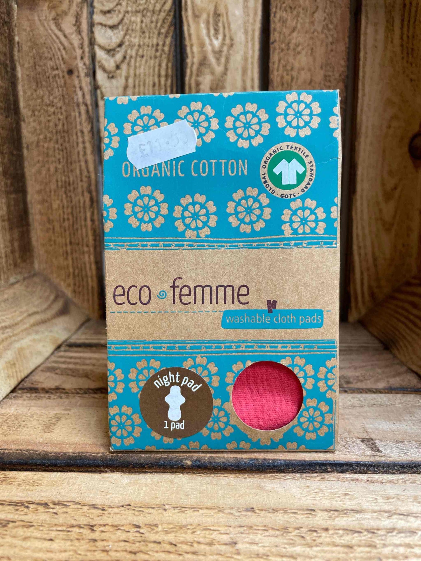 Eco femme reusable organic cotton day pad packaging on wooden background.