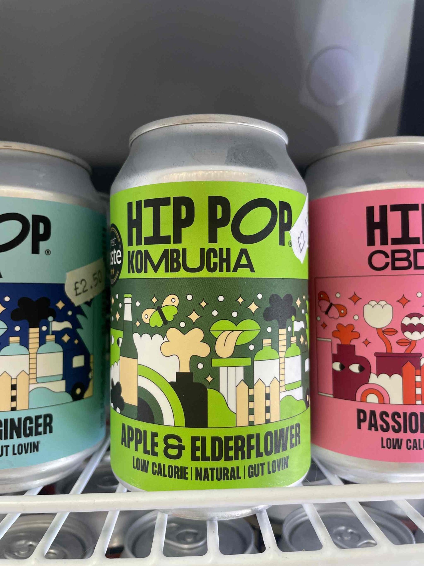 Hip Pop Apple Elderflower kombucha can in fridge with colorful label.