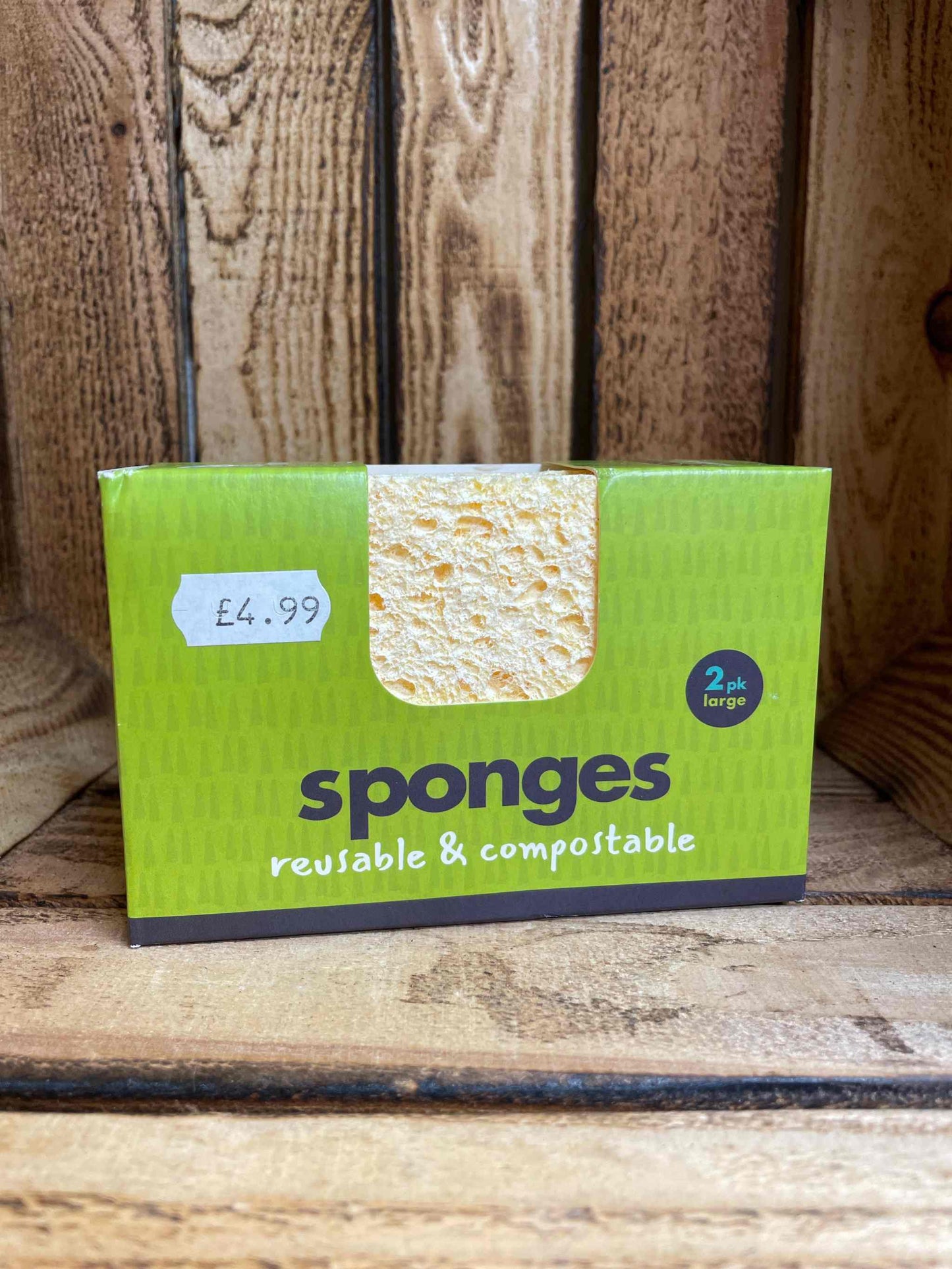 Compostable sponge 2 pack large in eco-friendly packaging on wooden background.