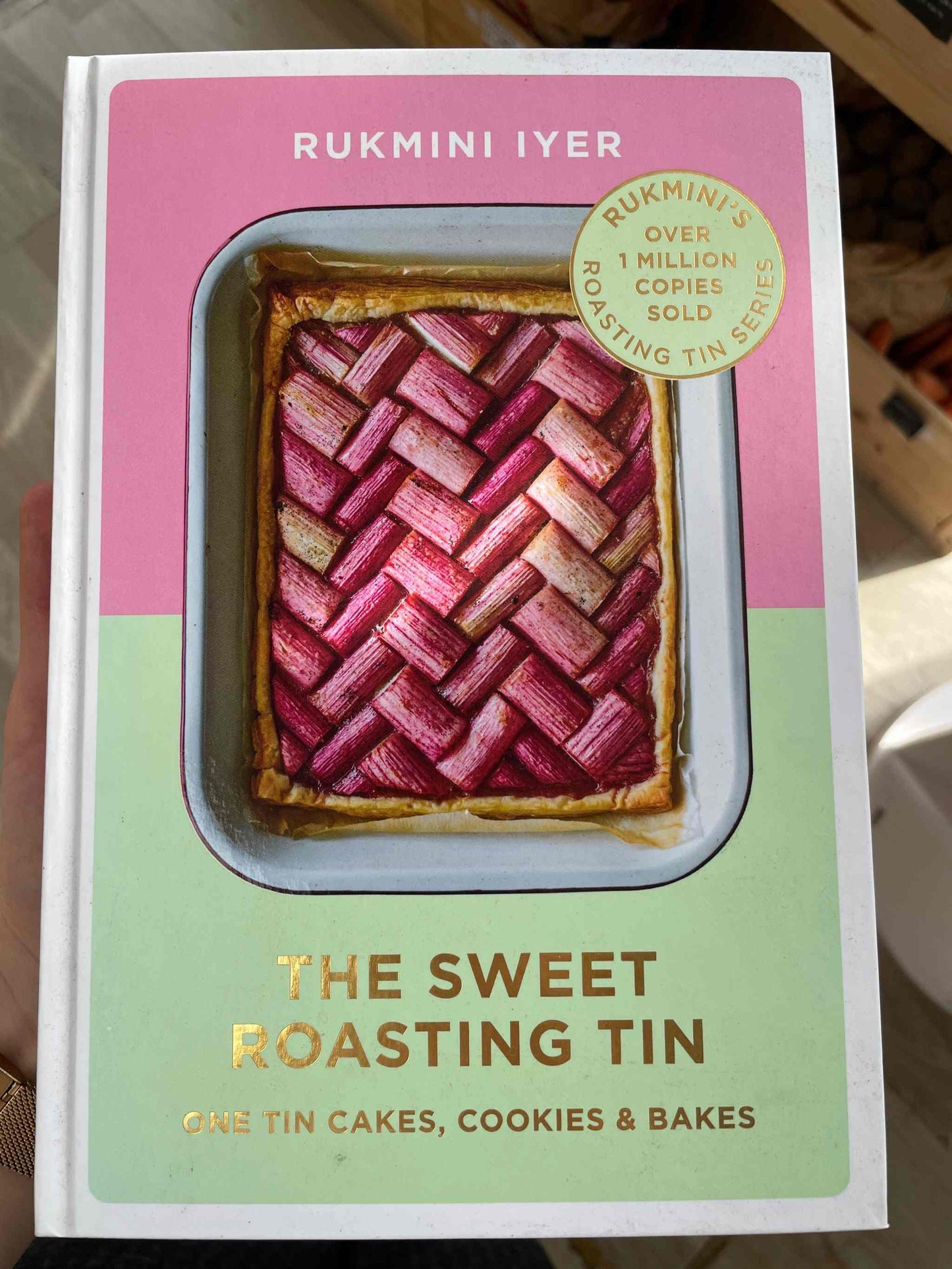 Sweet Roasting Tin cookbook cover featuring a vibrant pie design.