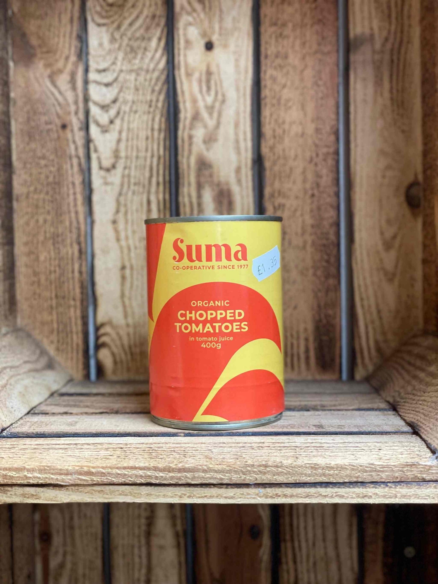 Organic Chopped Tomatoes can on wooden shelf
