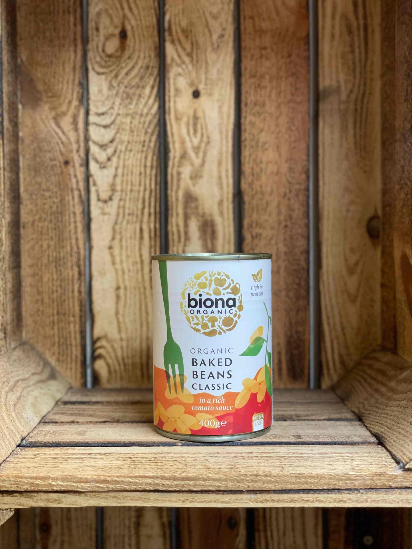 Biona Organic Baked Beans can on wooden shelf, rich in protein and fiber.