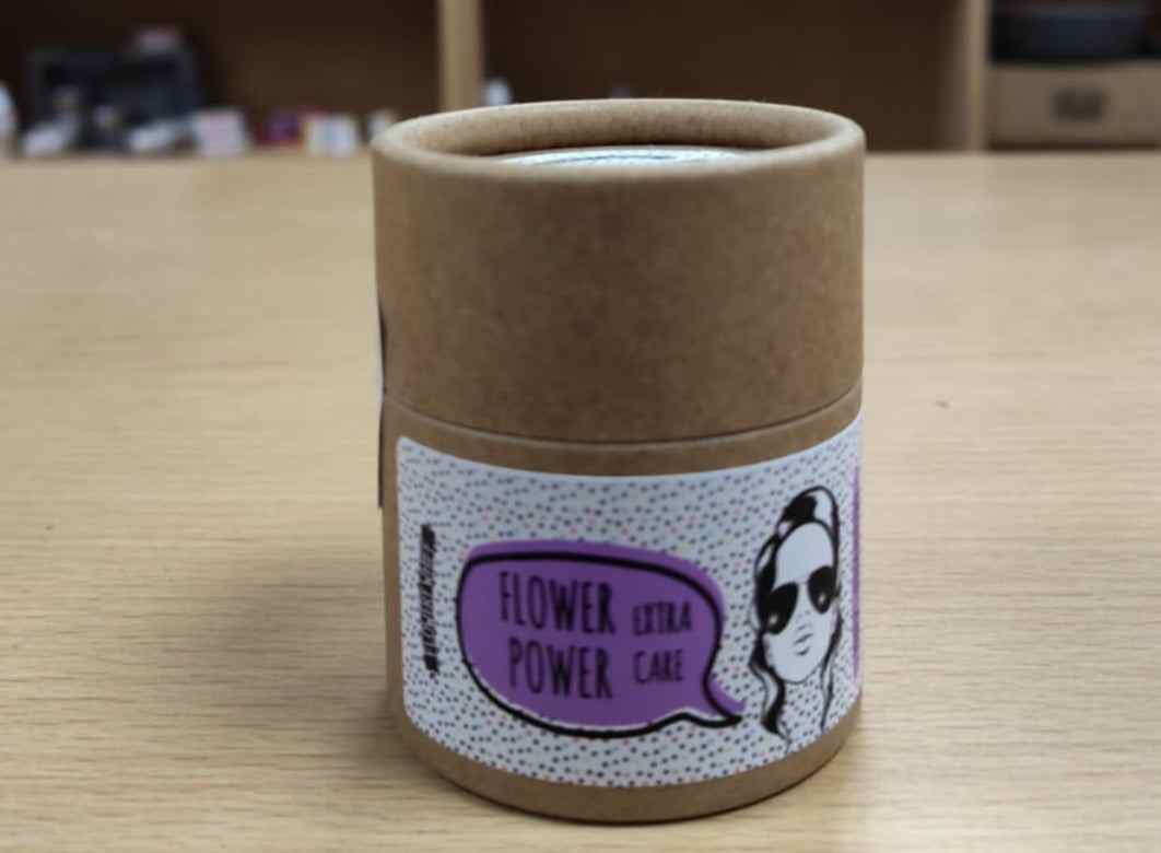 Dry Shampoo Shakers and Powder Flower Power in eco-friendly packaging on a wooden table.
