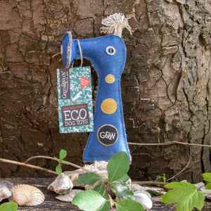 Eco-friendly dog toy Smorg by G&W in blue, with interactive features, against a rustic tree background.