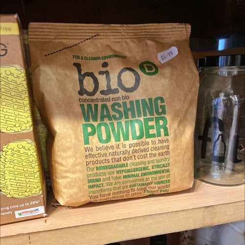 Eco-friendly Bio D concentrated laundry powder packaging on store shelf.