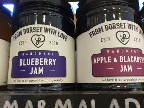 From Dorset with Love Blueberry and Apple & Blackberry jam jars on a shelf.