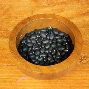 Organic black turtle beans in a wooden bowl, nutritious and sustainable.