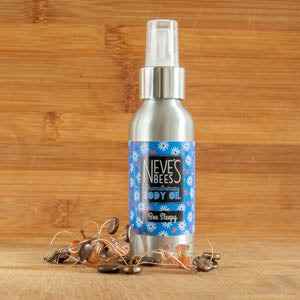 Aromatherapy Body Oil by Neve's Bees displayed on wooden background.