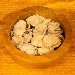 Bran flakes malted in a wooden bowl showcasing nutritional cereal.