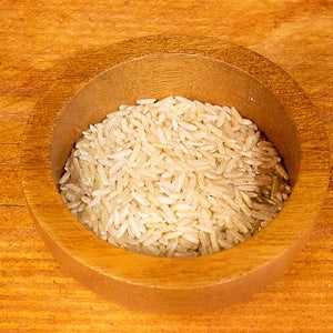 Brown basmati rice in wooden bowl, 100g portion.