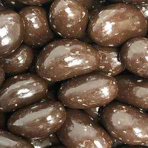 Dark chocolate-coated brazil nuts - close-up of glossy, rich treats.