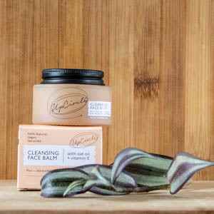 Cleansing Face Balm by UpCircle on a wooden surface with packaging, featuring eco-friendly, natural ingredients for radiant skin.