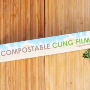 Compostable cling film eco-friendly kitchen solution on wooden background.