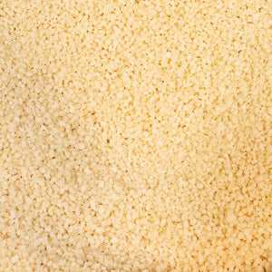 Couscous grains close-up, 100g, light and fluffy texture.