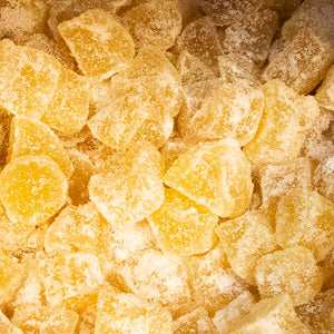 Crystallised ginger pieces covered in sugar, showcasing their sweet and spicy texture.