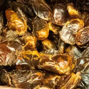 Premium pitted dates, 100g pack, showcasing natural sweetness and rich, caramel-like flavor.