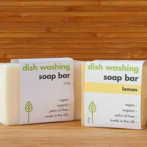 Dish washing soap bar by ecoLiving on wooden surface, eco-friendly packaging.