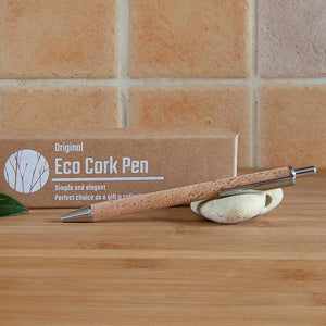Eco-friendly refillable cork pen on wooden surface with packaging box.