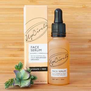 UpCircle face serum with organic ingredients and coffee oil, packaged in a recyclable glass bottle.