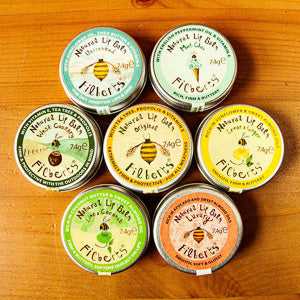 Filberts of Dorset natural lip balm collection on wooden surface.